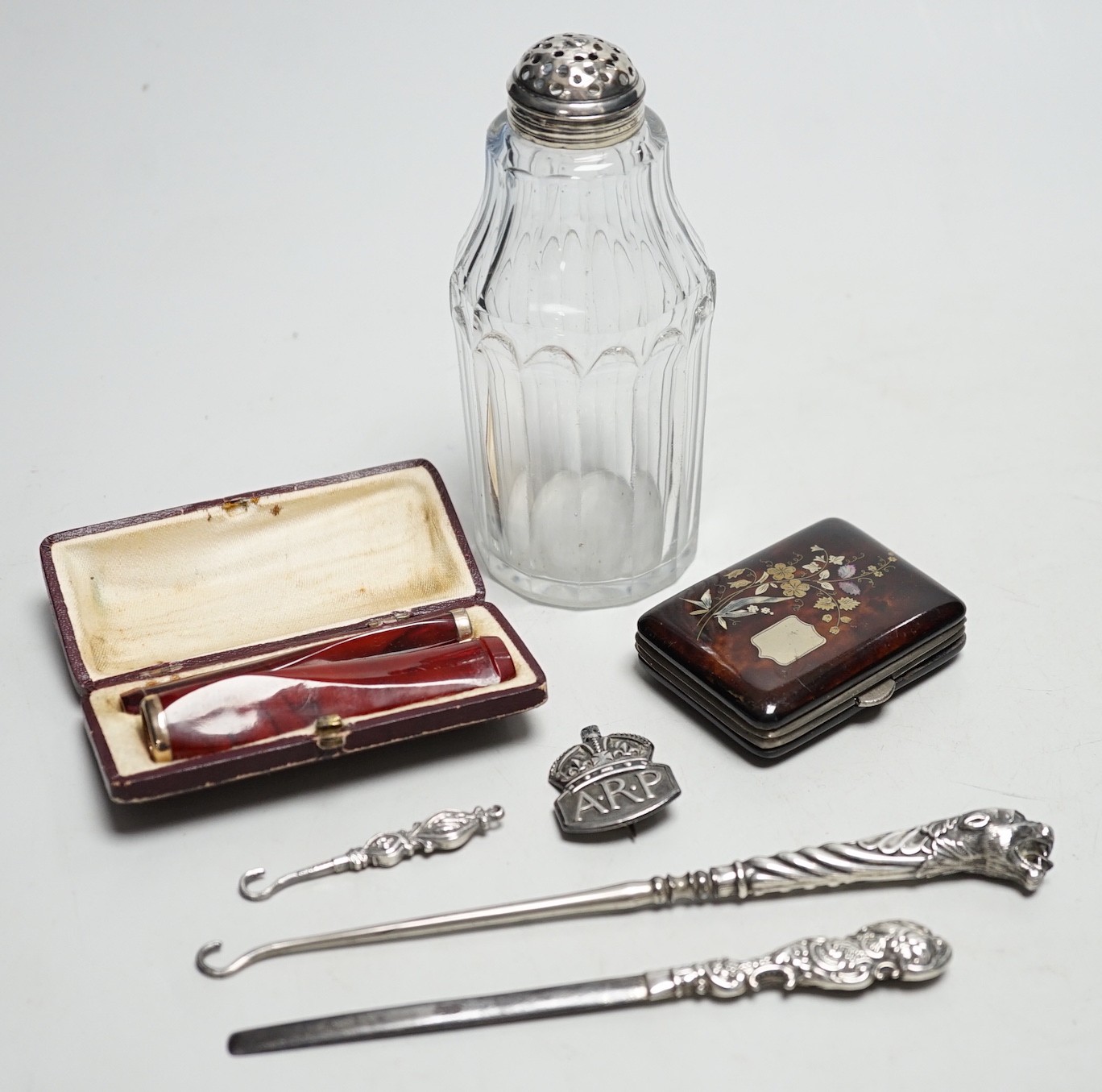 A Georgian silver mounted sugar sifter, a tortoiseshell and plique case, four silver items and two cased cheroot holders